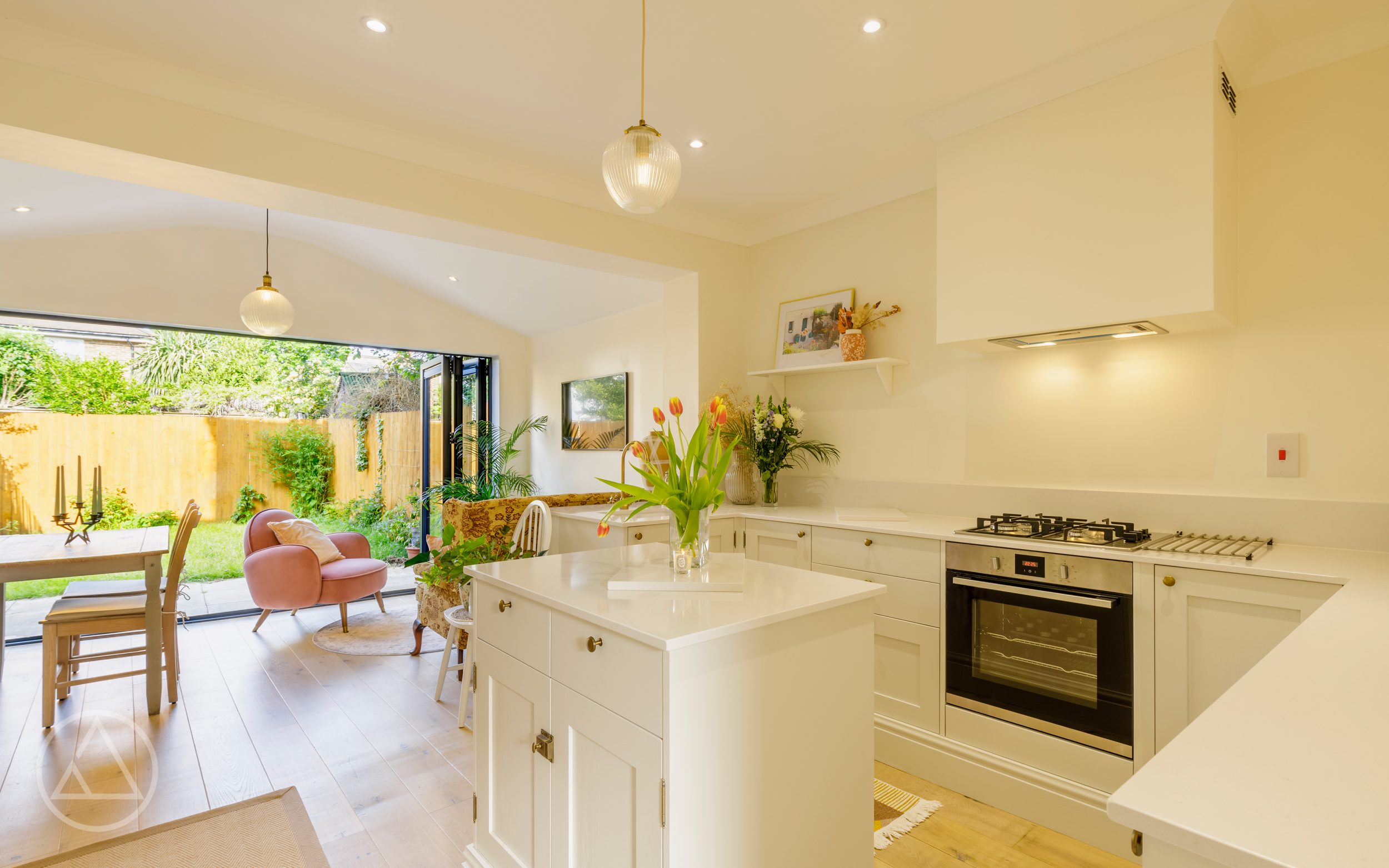 Cream shaker kitchen on Nelson Road with a quartz-topped island, looking through to the extension and garden