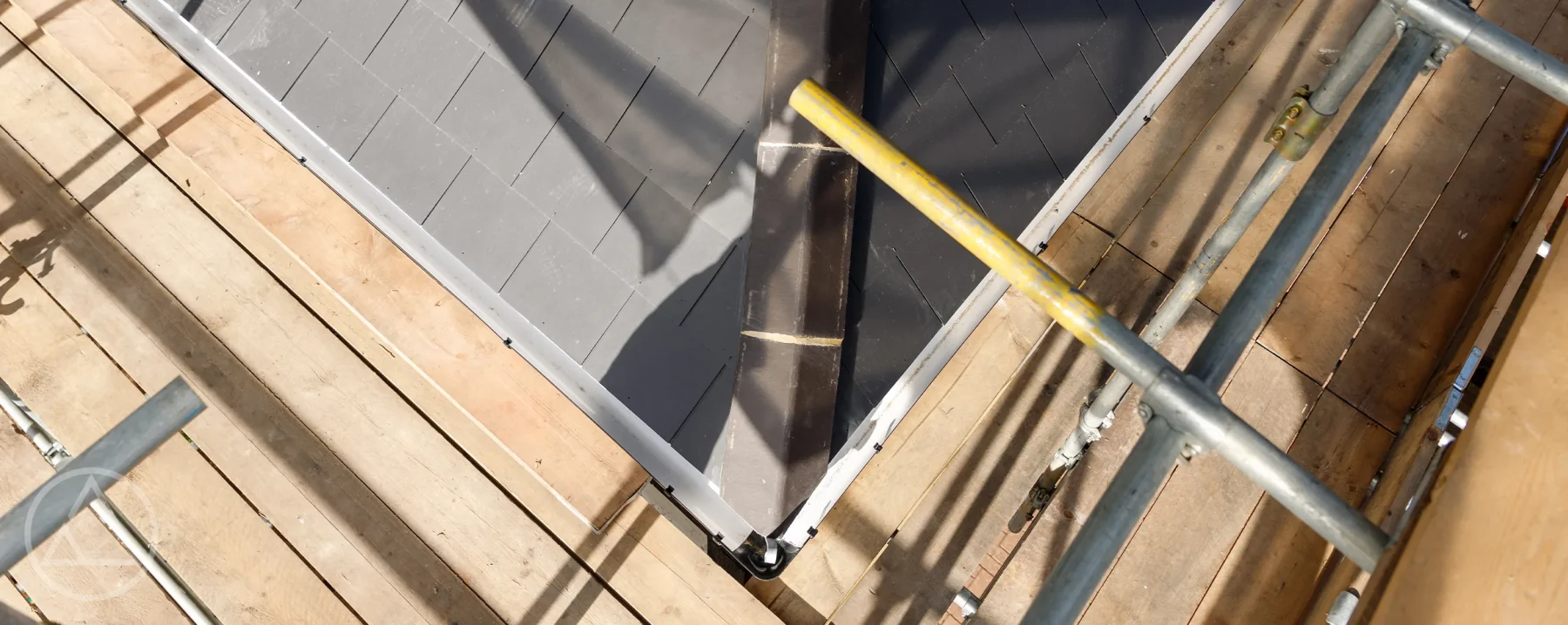 Completed slate loft conversion roof seen from the scaffolding