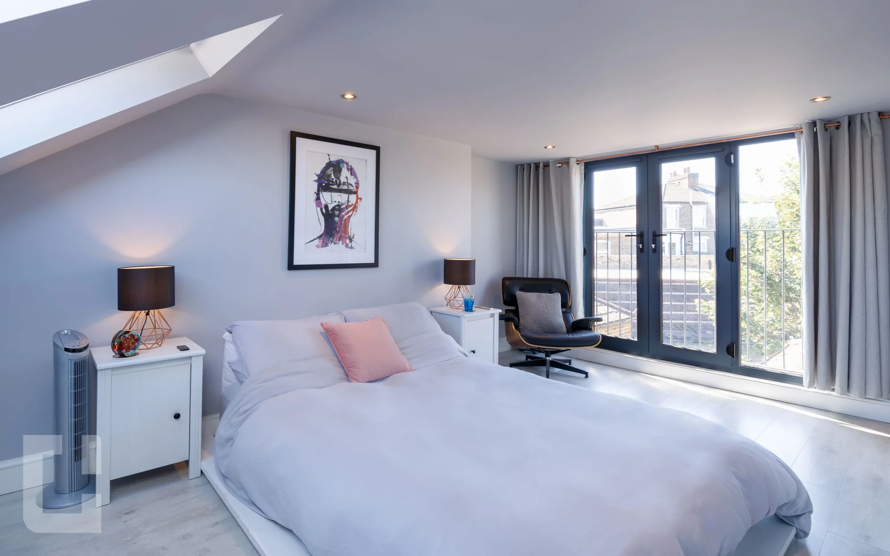 Loft bedroom on Bolton Road with full-height Juliet balcony doors and a rooflight in the opposite slope