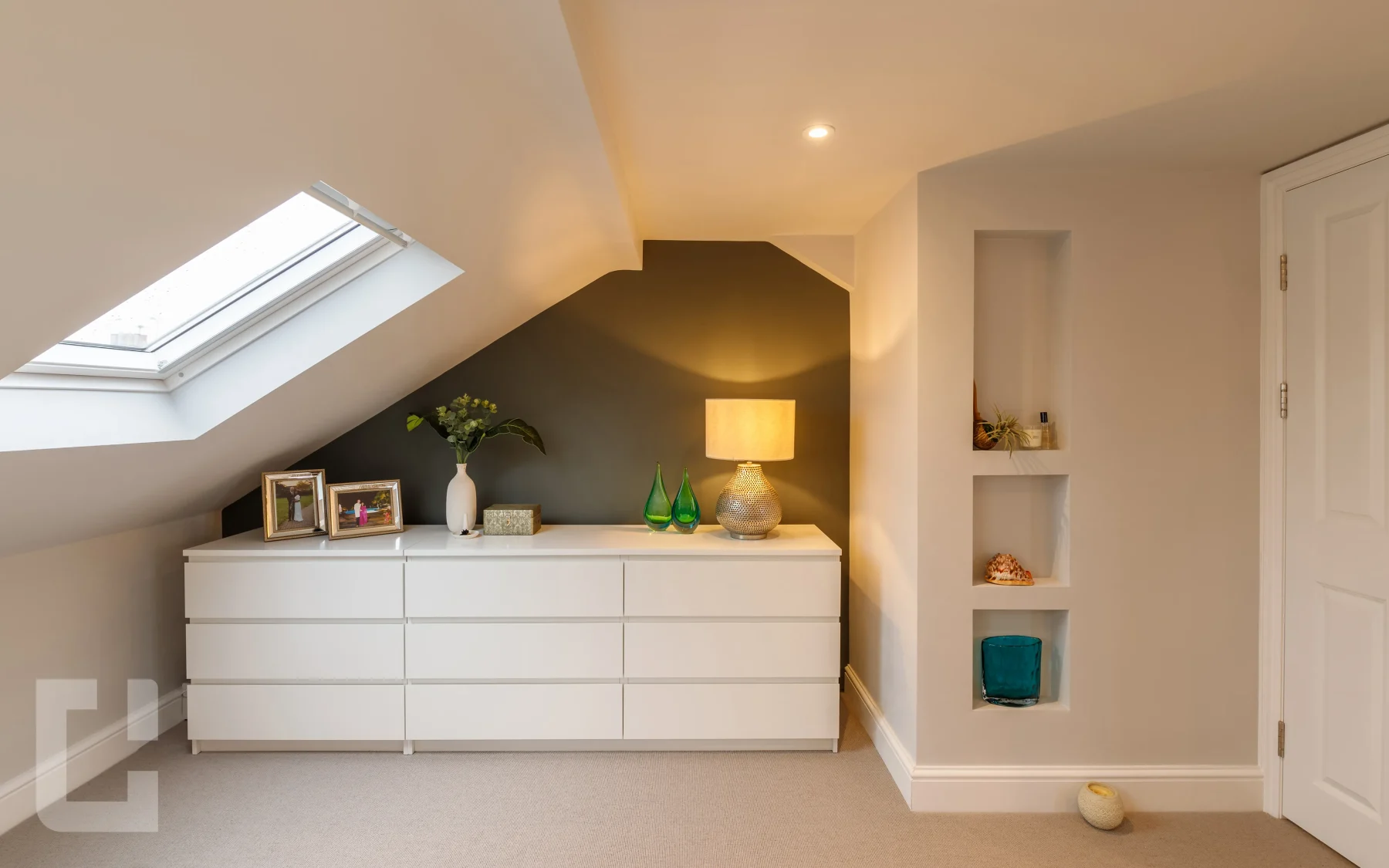 Loft bedroom on Cavendish Road with a rooflight, charcoal feature wall and three recessed display niches