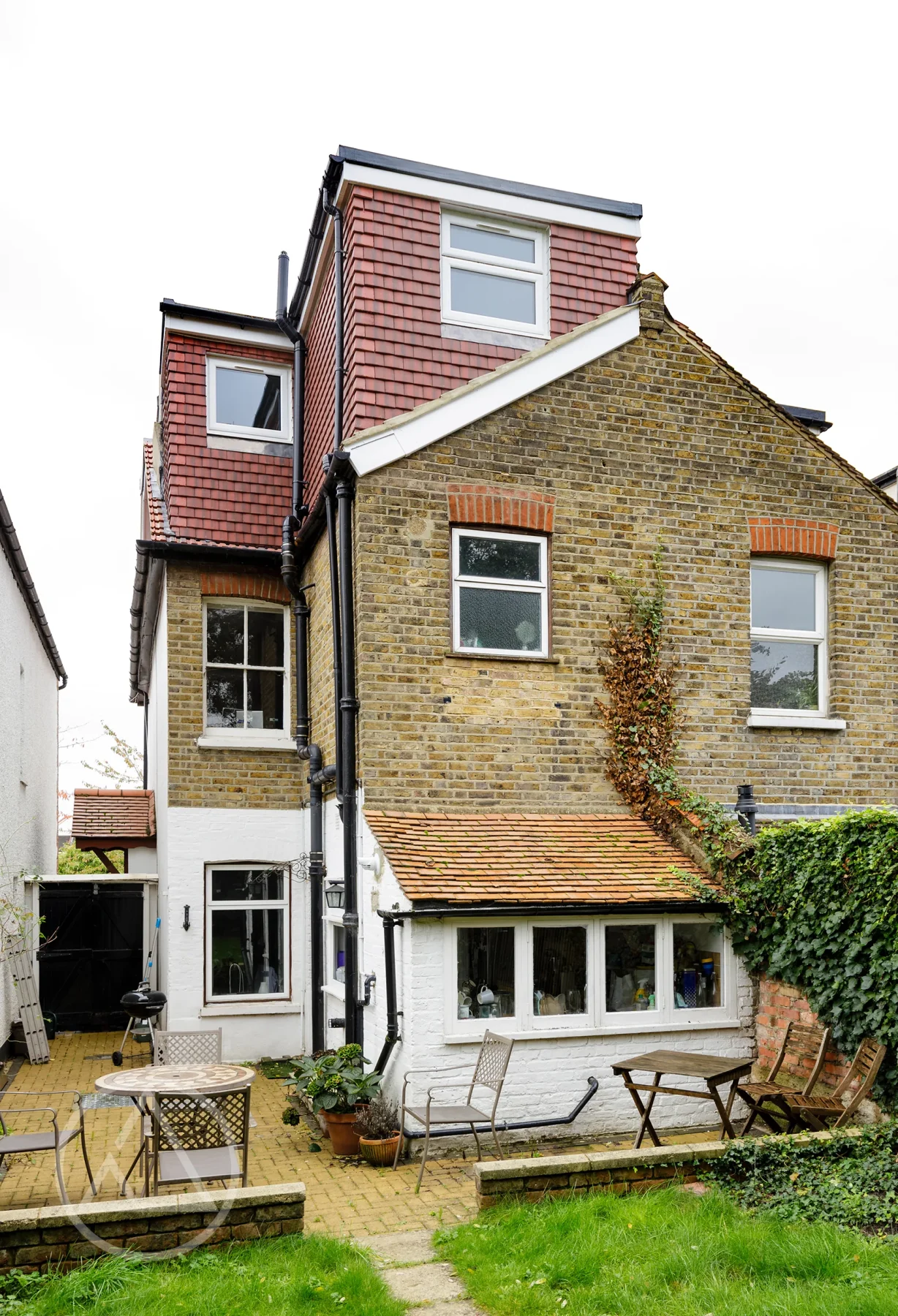 Rear elevation showing a red tile-hung L-shaped dormer above yellow stock brickwork